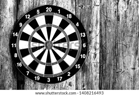 Bullseye is a target of business. Dart is an opportunity and Dartboard on old wood background.