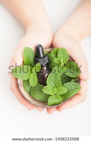 Peppermint essential oil, white background and copy space 
