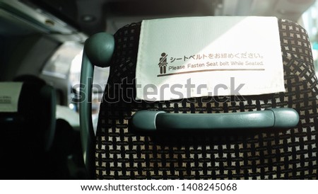 image of fasten seat belt while seated sign on bus 