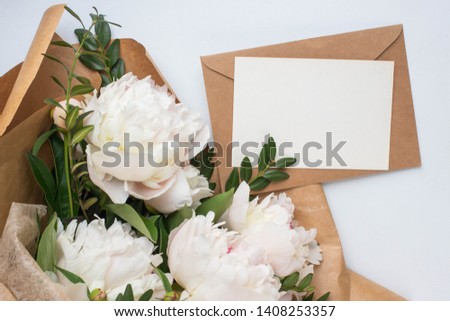 Minimalistic card mockup with peony, flower, craft envelope, wedding invitation, flat lay, top view