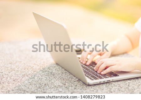 Close-up of business female working with laptop in at the park on office outdoor.