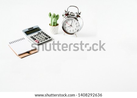 Top view objects clock, small cearamic cactus green ,calculation and small notebook on white background isolated, idea home loan background or home finance concept. sensitive focus.