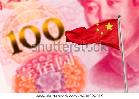 Waving red national flag of China against hundred chinese yuan banknote background. Finance concept.