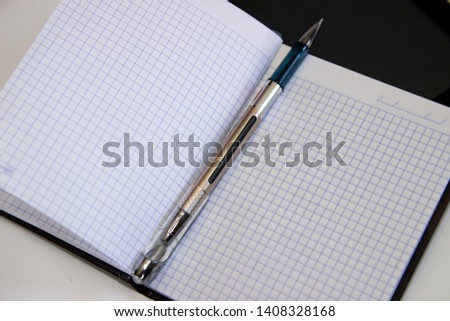 photo tablet, notebook and pen on white background