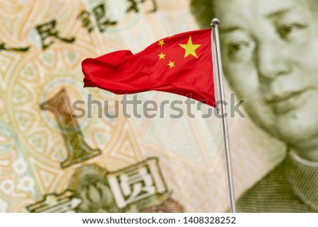 Waving red national flag of China against one chinese yuan banknote background. Finance concept.