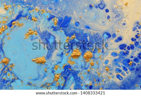 photography of abstract marbleized effect background. Blue creative colors. Beautiful paint with the addition of gold