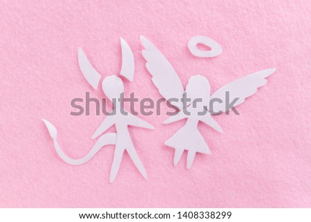devil man and angel woman on pink background