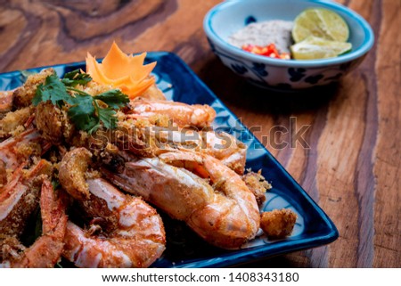 Shrimp fried with garlic decorated on wood table 
