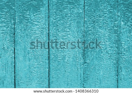 Blue cracked paint on wood vintage texture. Painted old wooden aquamarine wall background. Wooden grunge background