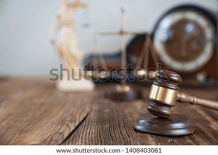 Law concept. Judge gavel, statue of the justice. Wooden table. 