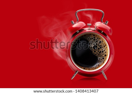 Hot coffee in a retro alarm clock. Wake up alarm coffee concept.  Royalty-Free Stock Photo #1408413407