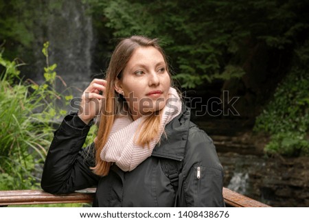 Portrait shot of a young 25 year old woman in the nature - travel photography
