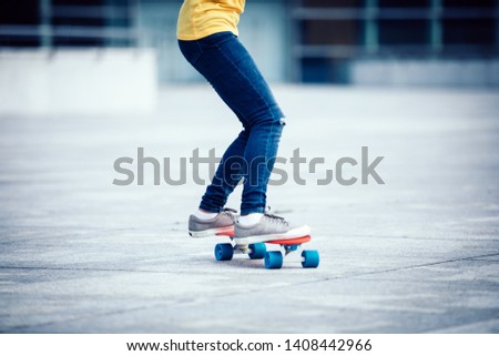 woman skateboarder legs skateboarding at city