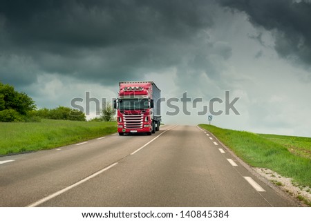 Fast truck on highway on a stormy weather