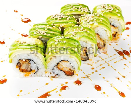 uramaki sushi roll with smoked eel unagi covered by avocado and sesame seeds on white background Royalty-Free Stock Photo #140845396