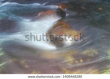 Water flow down on a yellow rock surface