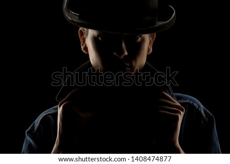 Silhouette of young unknown woman with kowboy hat on black background