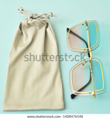Trendy sunglasses on blue background.