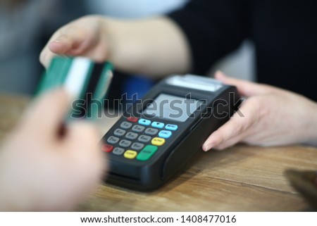 Cashier Hand Taking Plastic Credit Card to Payment. Electronic Money Transaction via Bank Terminal. Commerce Machine for Online Financial Operation. Using Technology Device Close-up Photography