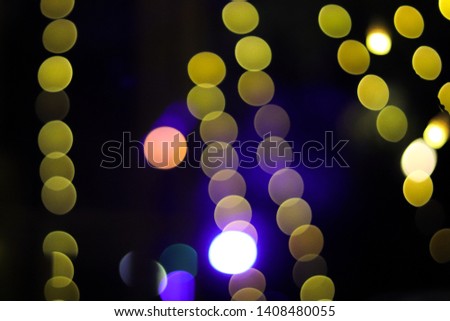Yellow and red bokeh balls with blue flare.