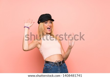 Young blonde woman with hat nervous and scared