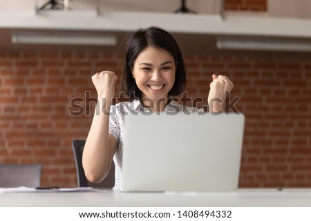 Overjoyed euphoric asian business woman worker feel winner celebrate online win looking at laptop computer, happy chinese student excited with great internet success professional triumph opportunity Royalty-Free Stock Photo #1408494332