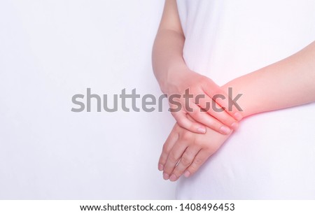 Pain and inflammation in the hand on the wrist of a girl, carpus, tendonitis and podagra, white background, copy space Royalty-Free Stock Photo #1408496453