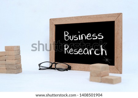 Business Research, Business Concept. Eye glasses and Wood block stacking as step stair isolated on grey background
