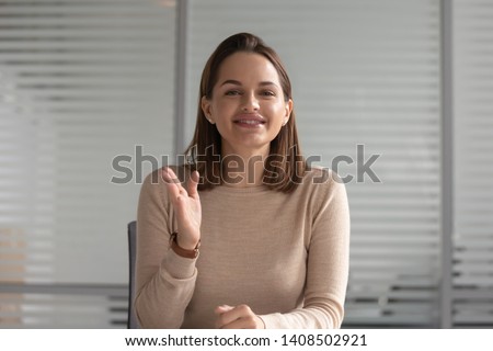Smiling business woman hr talking with distant client looking at camera calling for online job interview record online training webinar, female teacher coach shoot video training, webcam view Royalty-Free Stock Photo #1408502921