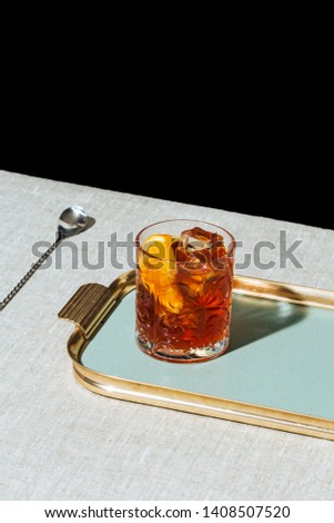Negroni, an italian cocktail, an apéritif, first mixed in Florence, Italy, in 1919. Count Camillo Negroni asked to strengthen his Americano by adding gin rather than normal soda water. Royalty-Free Stock Photo #1408507520
