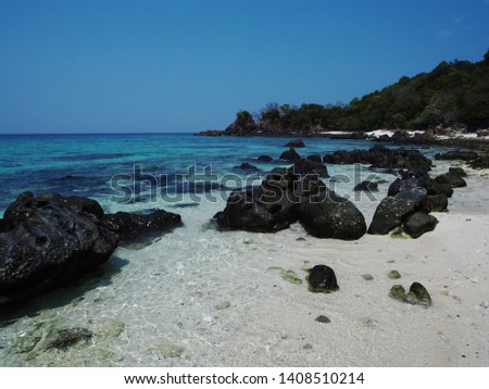 Ocean with rocks and foam at sand of coastline picture. Lipe Island, Thailand