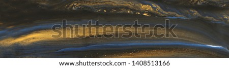 photography of abstract marbleized effect background. Blue and black creative colors. Beautiful paint with the addition of gold