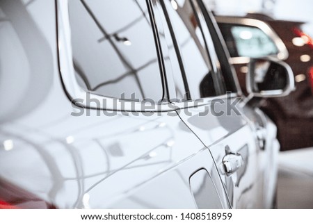 Close up view on car car body in dealership shop with noise grain effect. Business success concept. Car for sale