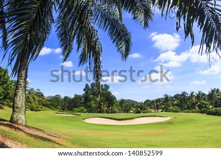 Scenic Green and bunker at 8th hole on Green Valley/St. Andrews golf course near Pattaya, Thailand Royalty-Free Stock Photo #140852599