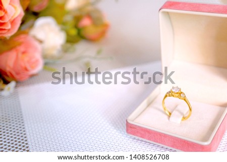 Soft image of Golden ring with diamonds in pink jewelry box decorate with flower. Concept for Wedding , Love , Valentine's day, Happy Birthday. Copy space. Flat lay.