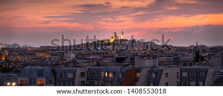 Sunset on the roofs of Paris with the Sacre Coeur and Montmartre. 