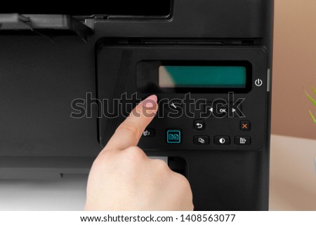 Woman using the printer to scanning and printing document