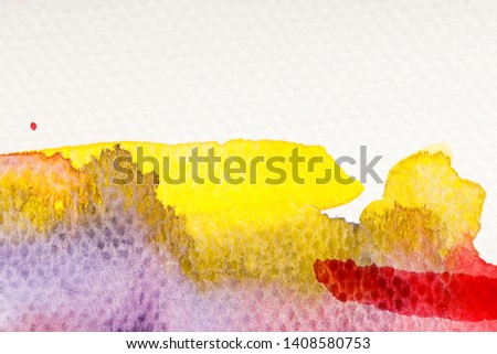 close up view of yellow, purple and red watercolor paint spills on white background with copy space