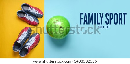 Bowling shoes and bowling ball on blue yellow background. Indoor family sports. Copy space