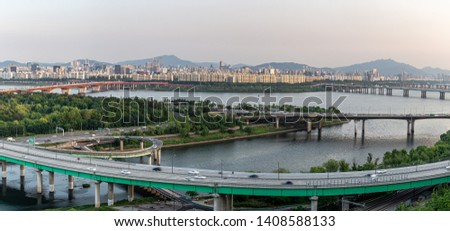 A panoramic landscape view of seoul, korea  around the bridge over the Han River before sunset with long exposure.( blur motion vehicle )