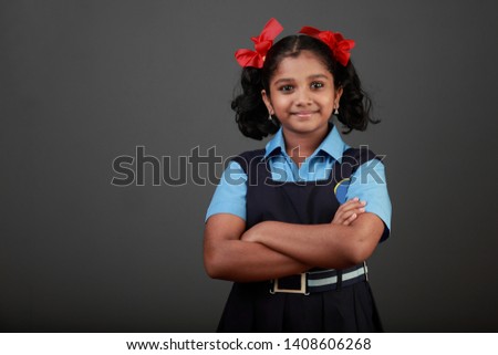 Portrait of little girl wearing school uniform