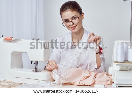 woman sews clothes on a sewing machine atelier beauty                              