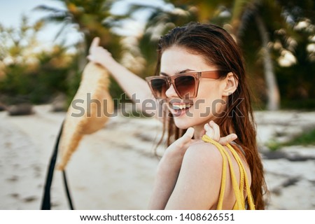    happy woman in glasses with hat on the beach ocean                            