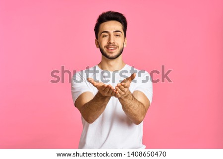 man with a beard in a white T-shirt hold in your hands a place free background logo                               