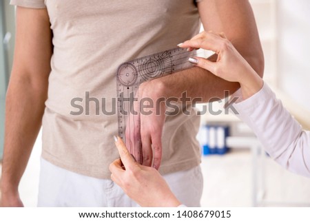 Female doctor checking patient's joint flexibility with goniometer