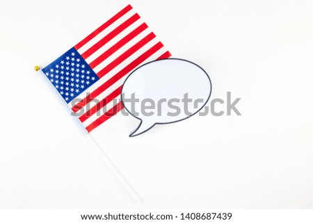 Creative top view flat lay of American flags for Elections, Memorial Day, 4th of July or Labour Day with bubble lightbox mockup with copy space white background. Concept of patriotism and independence