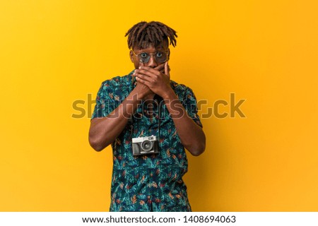 Young black rasta man wearing a vacation look shocked covering mouth with hands.