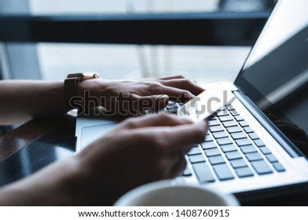 Hands of Woman shopping in Internet, making instant Payment Transaction at Computer, using Credit Card