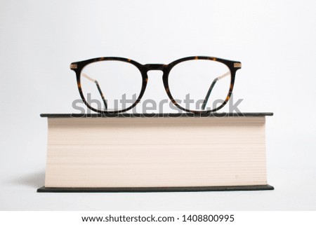 Book with Glasses on isolated white background in studio educational or business use