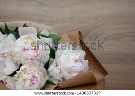 bouquet of peonies in craft paper